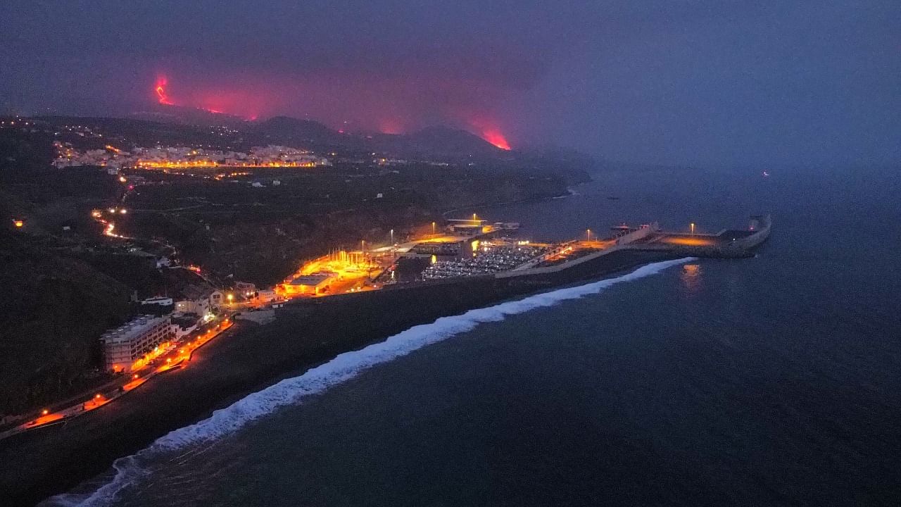 Lava is seen and smoke rises following the eruption of a volcano, in the Port of Tazacorte, on the Canary Island of La Palma, Spain. Credit: Reuters Photo