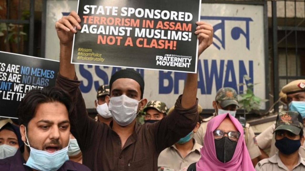 Students activists display placards to protest against a government eviction drive, which turned violent with killing two people in Assam, during a demonstration outside the Assam Bhawan in New Delhi on September 24, 2021. Credit: AFP Photo