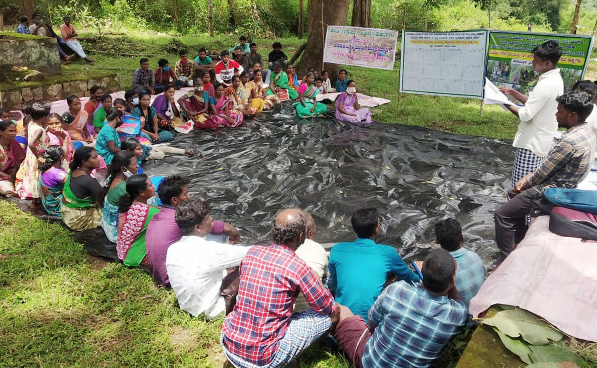 Members of the tribal communities take part in a meeting near Gonikoppa.