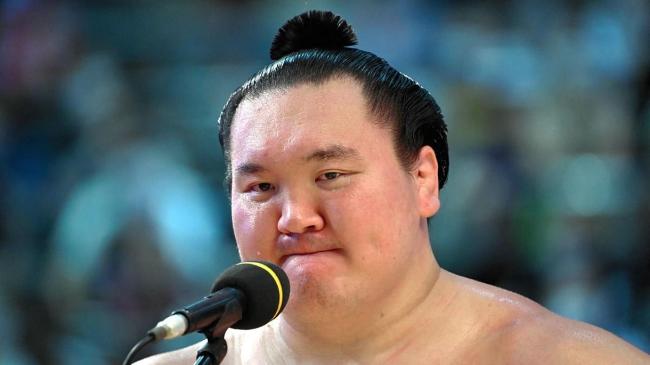 This picture taken on July 18, 2021 shows Mongolian-born sumo wrestler Hakuho reacting during the awards ceremony of the Grand Sumo Tournament in Nagoya, Aichi Prefecture. Credit: AFP file photo