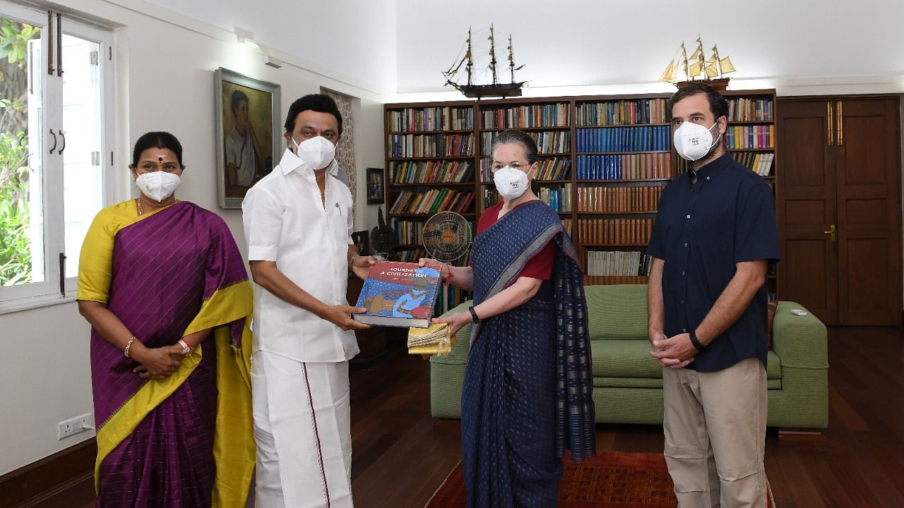 Tamil Nadu CM hands over a book as a gift to Congress interim chief Sonia Gandhi. Credit: Special Arrangement