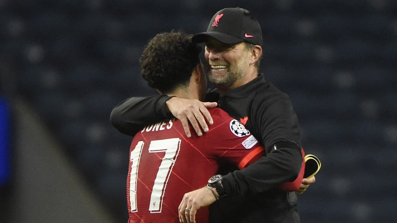 Curtis Jones and Jurgen Klopp (R). Credit: AFP Photo