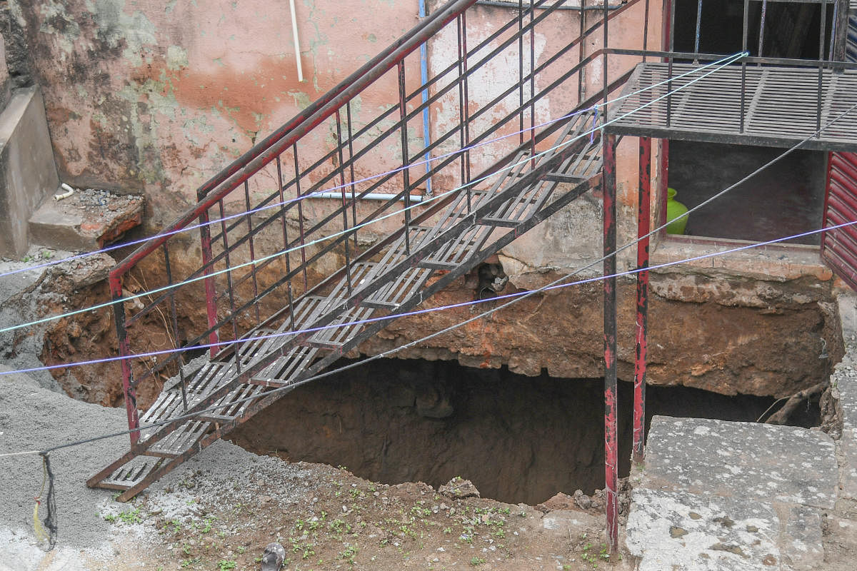 The sinkhole under a house on Tannery Road in Bengaluru on Thursday. DH Photo/S K Dinesh