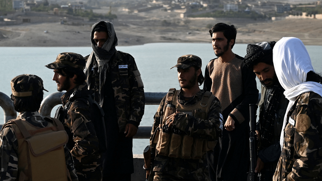 Taliban fighter patrol along a road at Qargha Lake on the outskirts of Kabul. Credit: AFP Photo