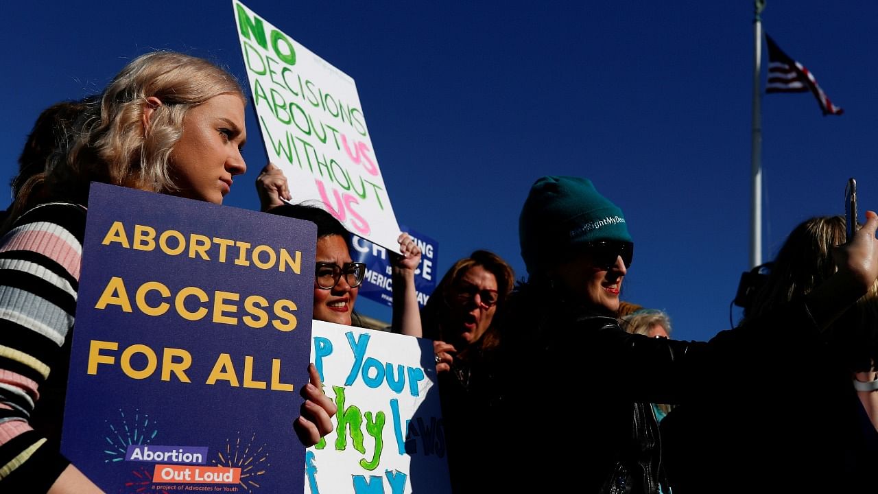 Pro-choice demonstrators hold up signs during a group chant outside of the US Supreme Court as justices hear a major abortion case on the legality of a Republican-backed Louisiana law that imposes restrictions on abortion doctors, on Capitol Hill in Washington, US, March 4, 2020. Credit: Reuters Photo