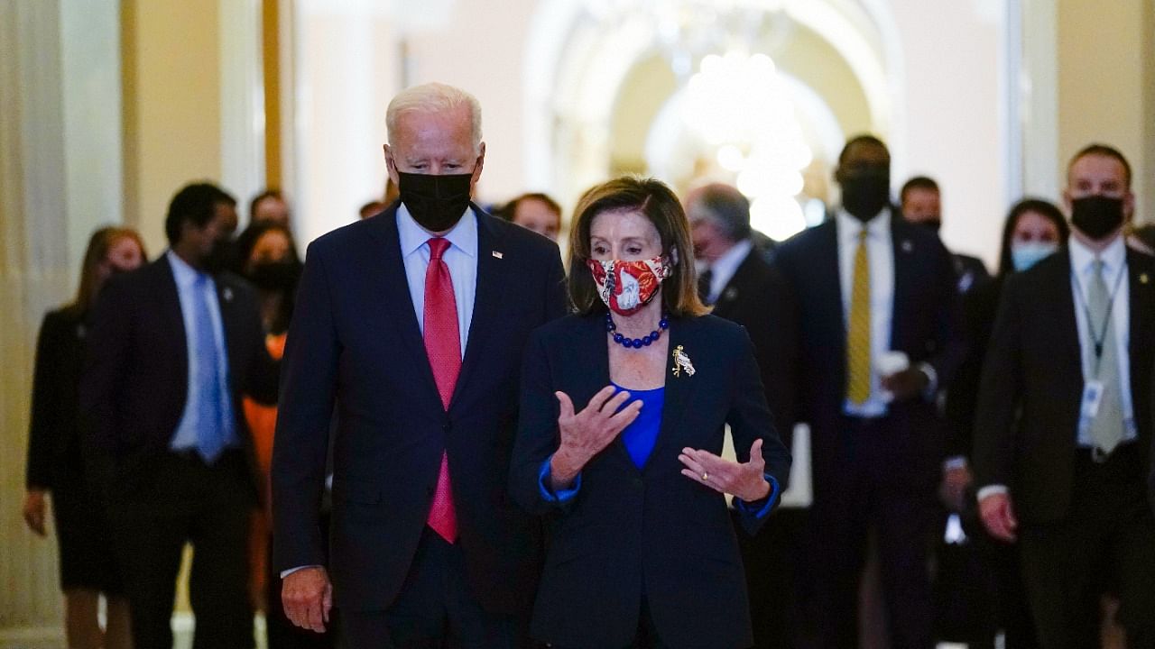 President Joe Biden walks with House Speaker Nancy Pelosi of Calif., on Capitol Hill in Washington, Friday, October 1, 2021, after attending a meeting with the House Democratic caucus to try to resolve an impasse around the bipartisan infrastructure bill. Credit: AP/PTI Photo