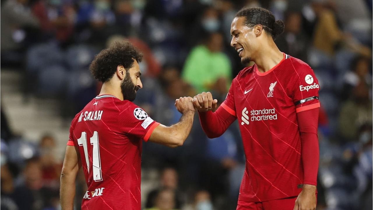 Liverpool's Mohamed Salah (L) with Virgil van Dijk (R). Credit: Reuters File Photo