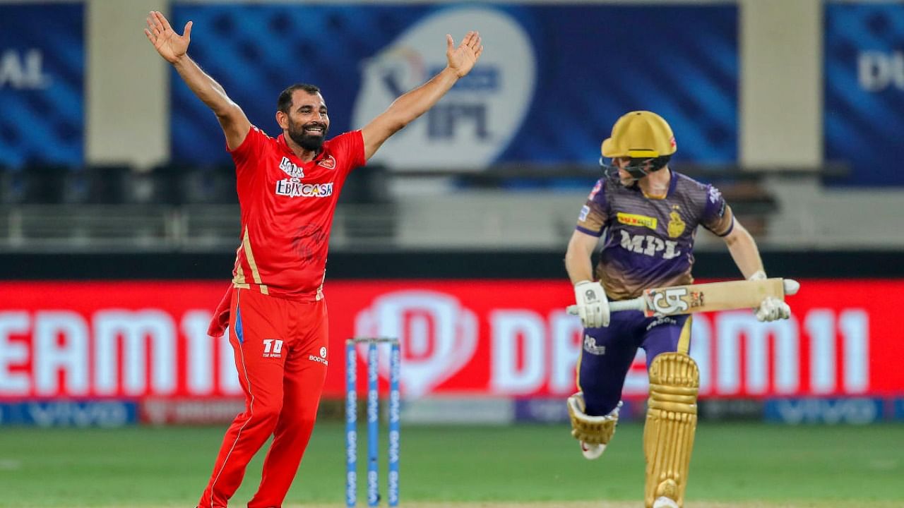 Mohammad Shami (L) of Punjab Kings appeals for the wicket of Eoin Morgan (R) captain of KKR