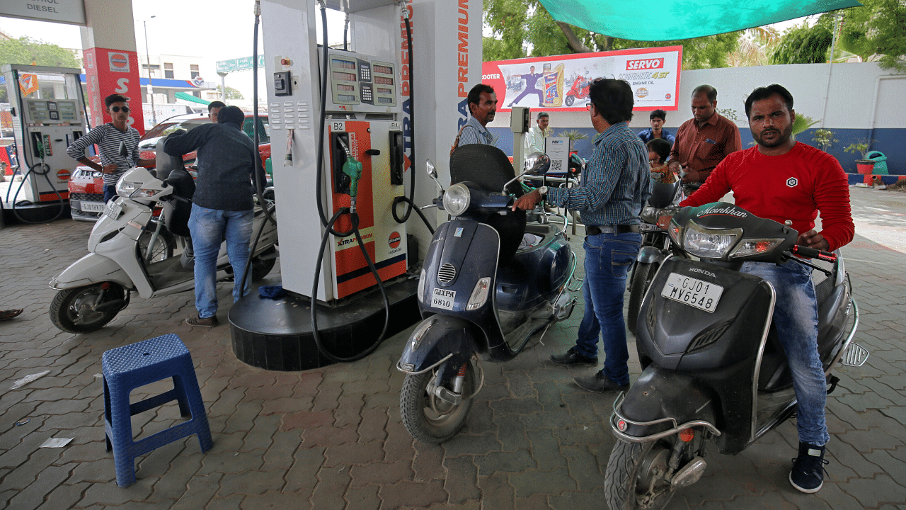 People get their two-wheelers filled with petrol at a fuel station in Ahmedabad, India. Credit: Reuters Photo
