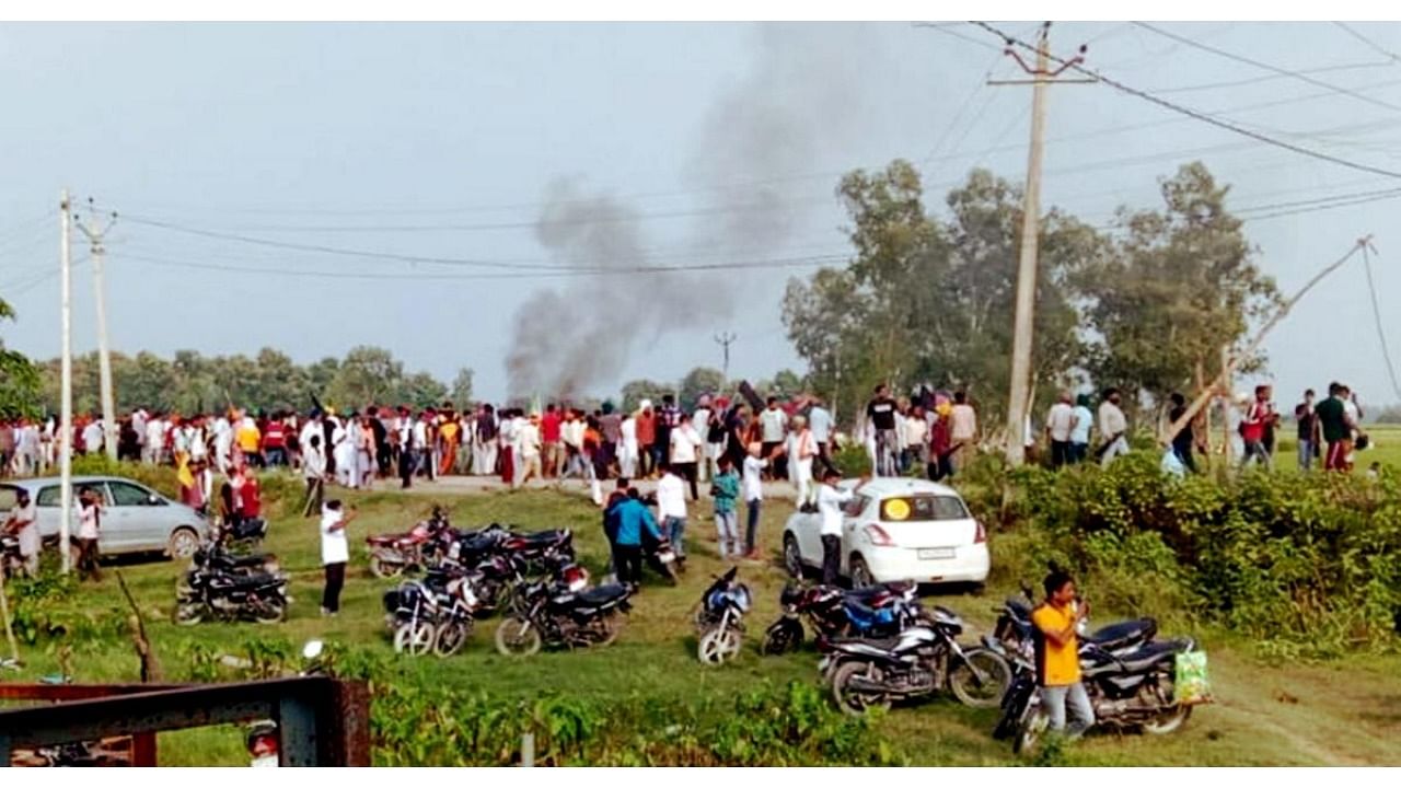 A vehicle set ablaze after violence broke out after farmers agitating were allegedly run over by a vehicle in the convoy of a union minister, in Lakhimpur Kheri. Credit: PTI Photo