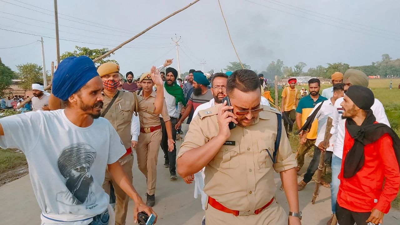 Farmers protest after two of the agitators were allegedly run over by a vehicle in the convoy of a union minister, in Lakhimpur Kheri. Credit: PTI Photo