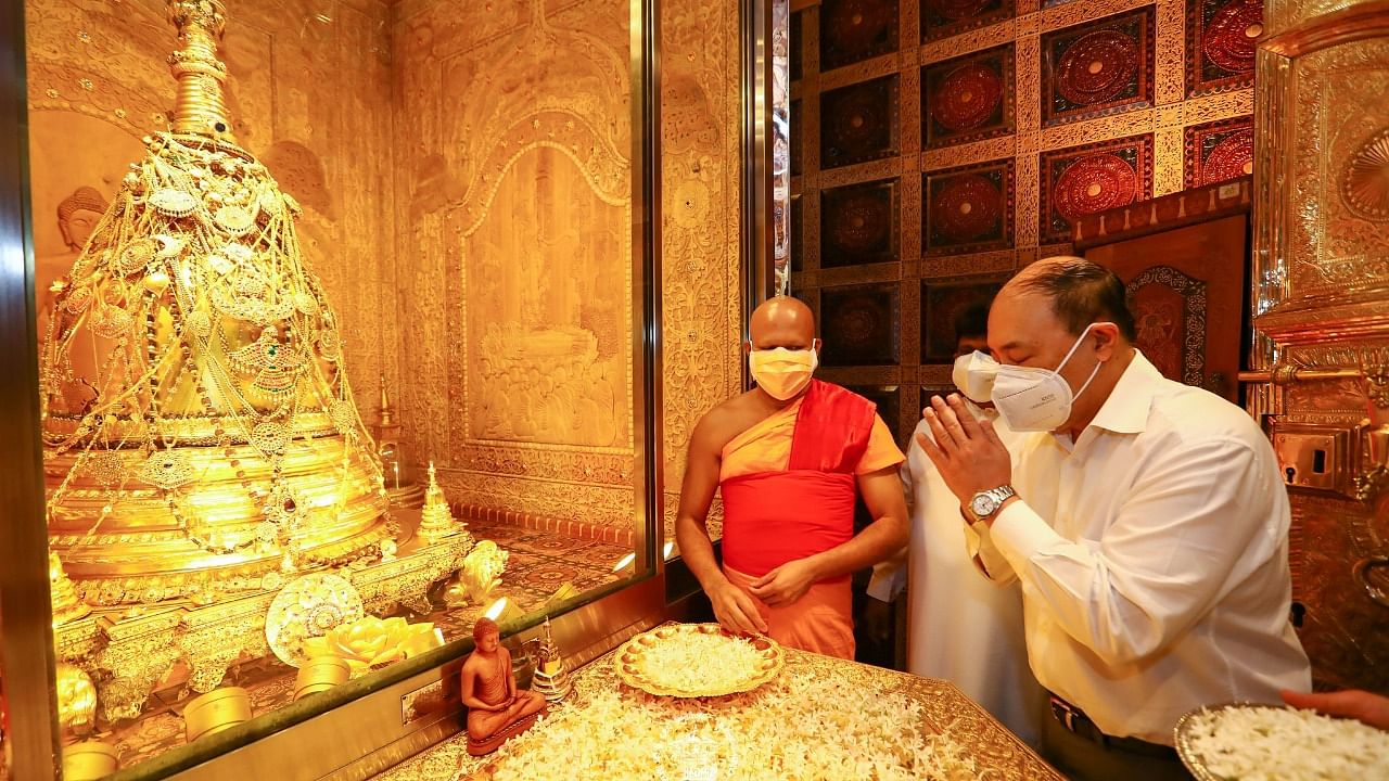 Indian Foreign Secretary Harsh Vardhan Shringla prays at the temple of the Sacred Tooth Relic. Credit: Twitter/@SriDalada