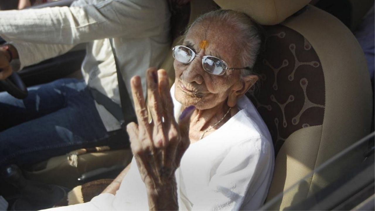 Heeraben Modi shows her finger marked with indelible ink after casting her vote during Gandhinagar municipal corporation elections. Credit: PTI Photo