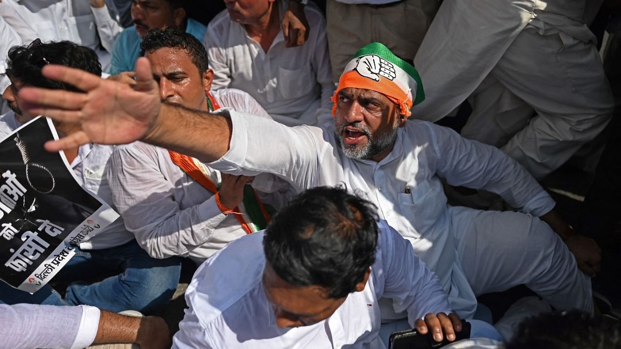 Congress party activists shout slogans during a demonstration outside the Bharatiya Janata Party (BJP) headquarters in New Delhi on October 4, 2021, a day after clashes with farmers who were protesting against the agricultural reforms at Lakhimpur in India's Uttar Pradesh state in which at least nine people were killed. Credit: AFP Photo