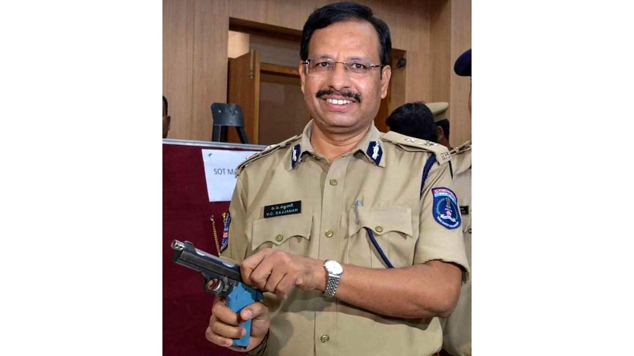 IPS officer V C Sajjanar pose with a gun. Credit: PTI File Photo