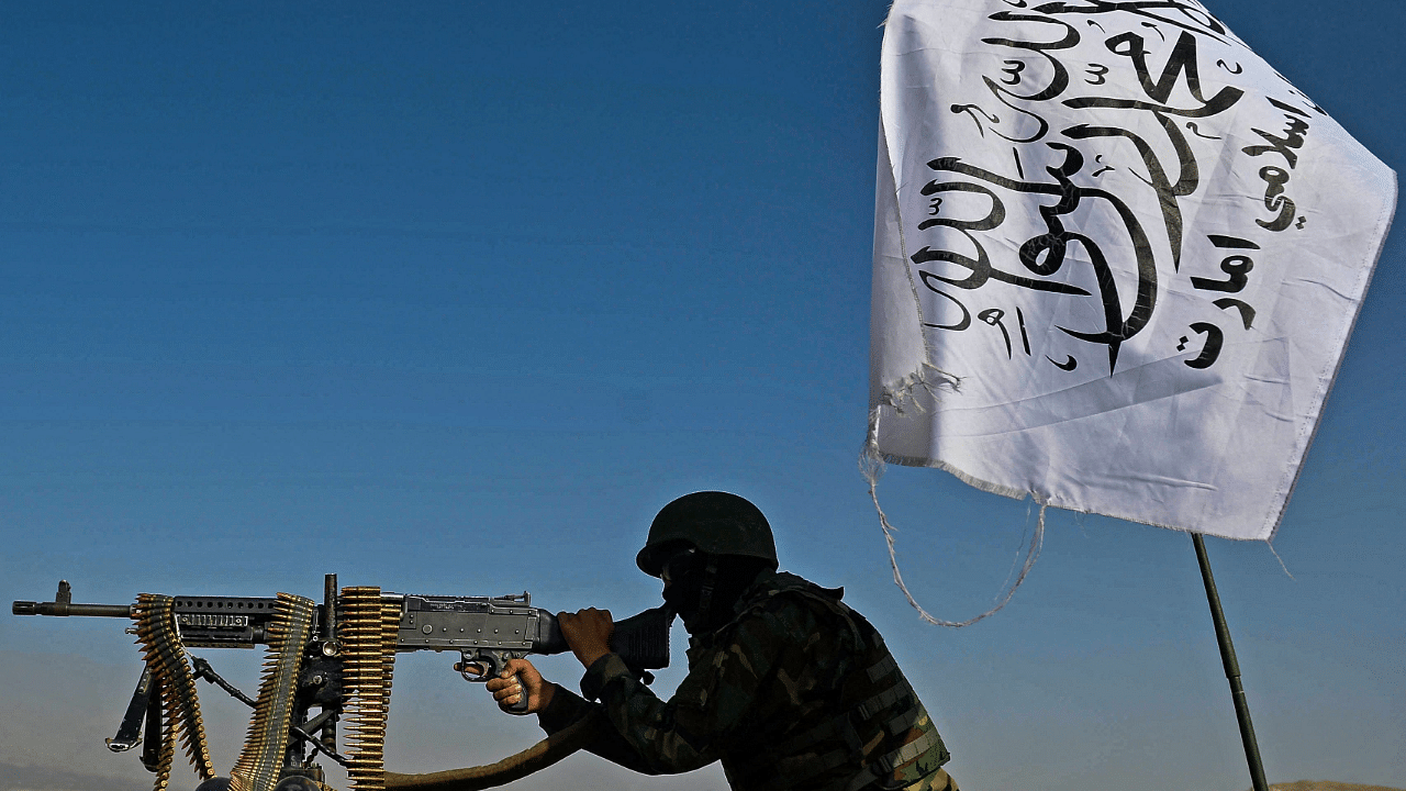 A Taliban fighter mans a machine gun mounted on a vehicle. Credit: AFP Photo