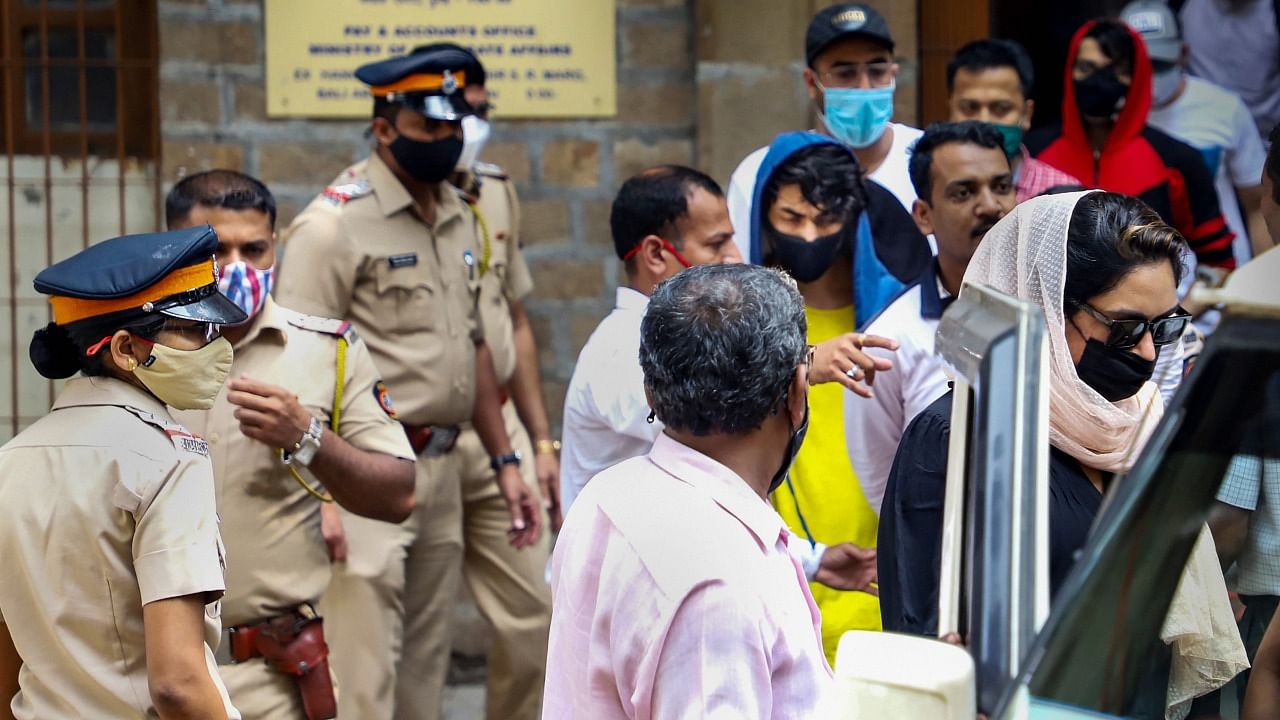 Bollywood actor Shah Rukh Khan's son Aryan Khan (wearing blue) leaves for hospital from Narcotics Control Bureau's office, in Mumbai, Monday. Credit: PTI Photo