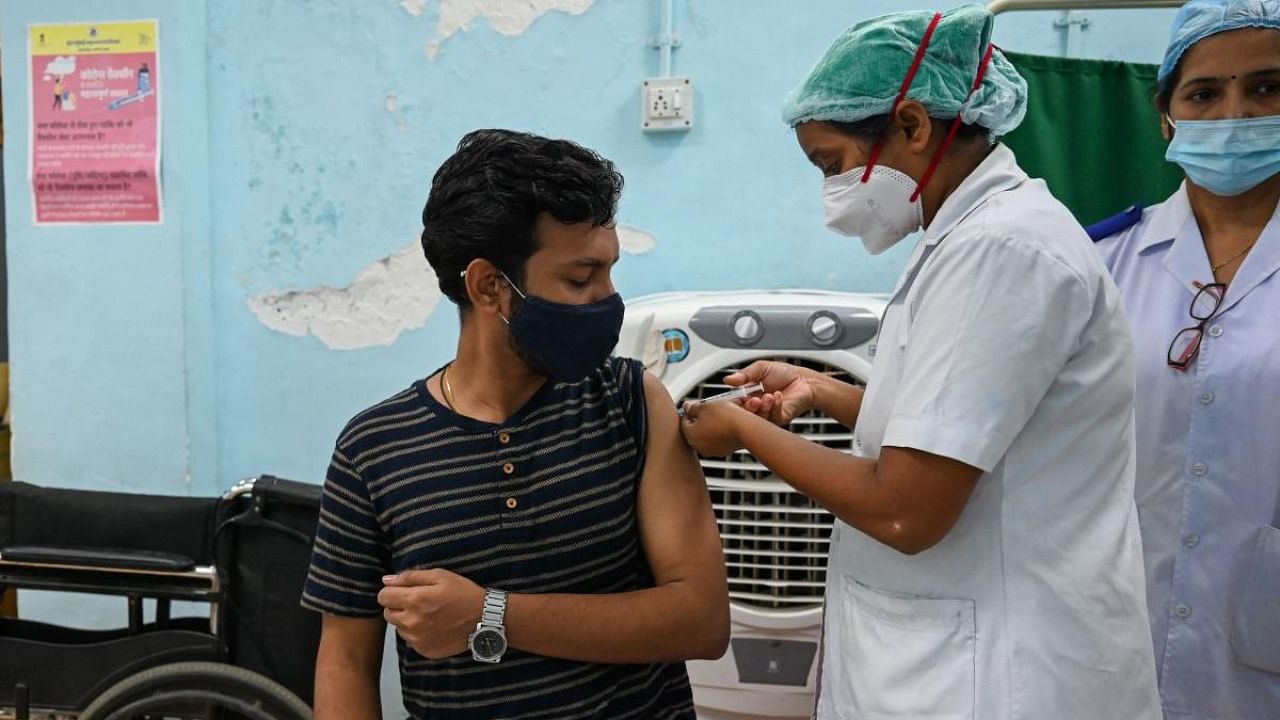 Healthworker administers a shot of Covid-19 vaccine in Mumbai. Credit: AFP Photo