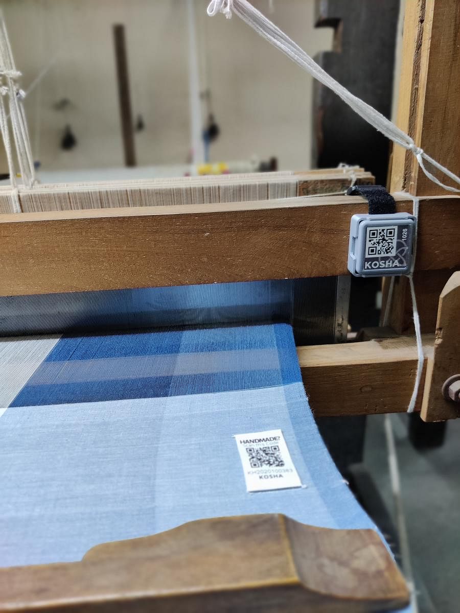 A Kosha device fixed on the handloom and a QR code stitched into the fabric help users check the authenticity of hand-woven products. Kosha certification hopes to check the practice of machine-made fabrics being marketed as hand-woven. (Picture credit: Ko