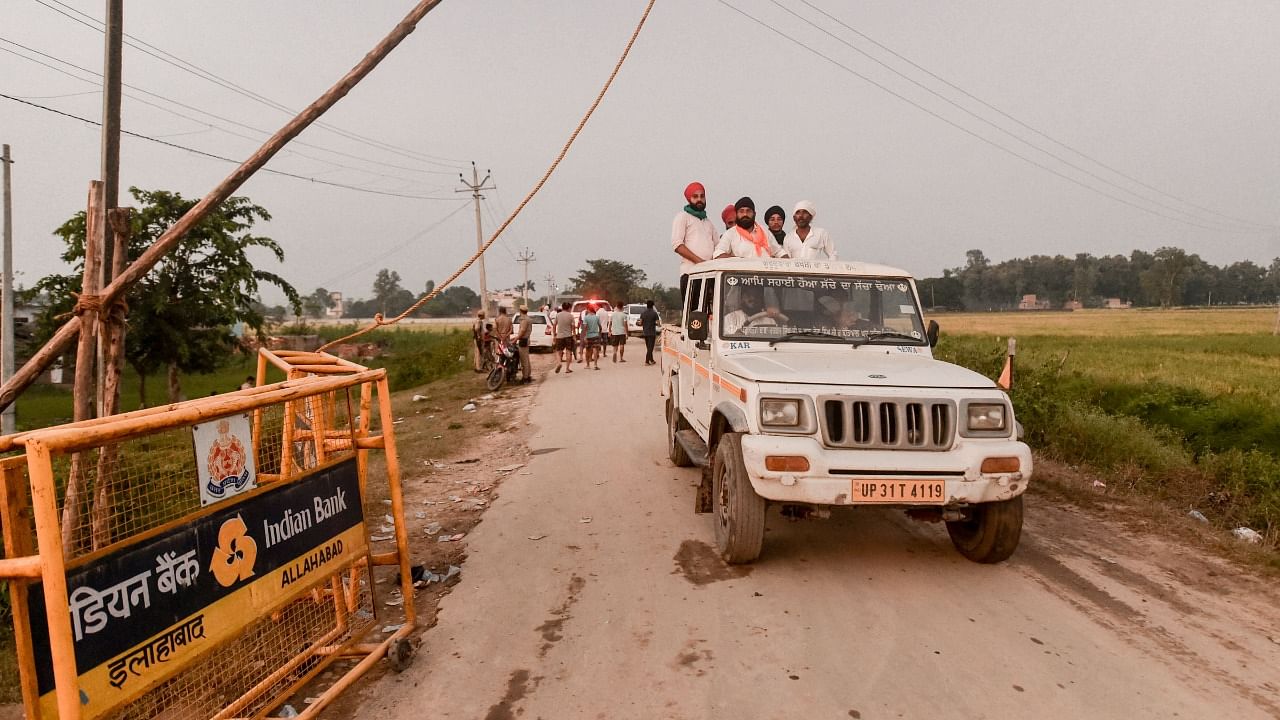 People who saw the violence, seen moving in the area at Tikonia in Lakhimpur Kheri district, Monday. Credit: PTI Photo