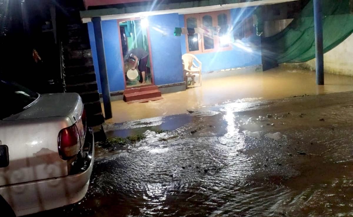 Stormwater gushes into a house near Sweepers' Colony in Somwarpet.