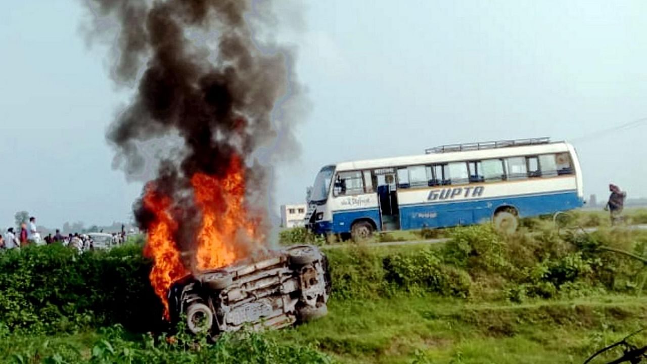 A vehicle set ablaze after violence broke out after farmers agitating were allegedly run over by a vehicle in the convoy of a union minister, in Lakhimpur Kheri. Credit: PTI file photo