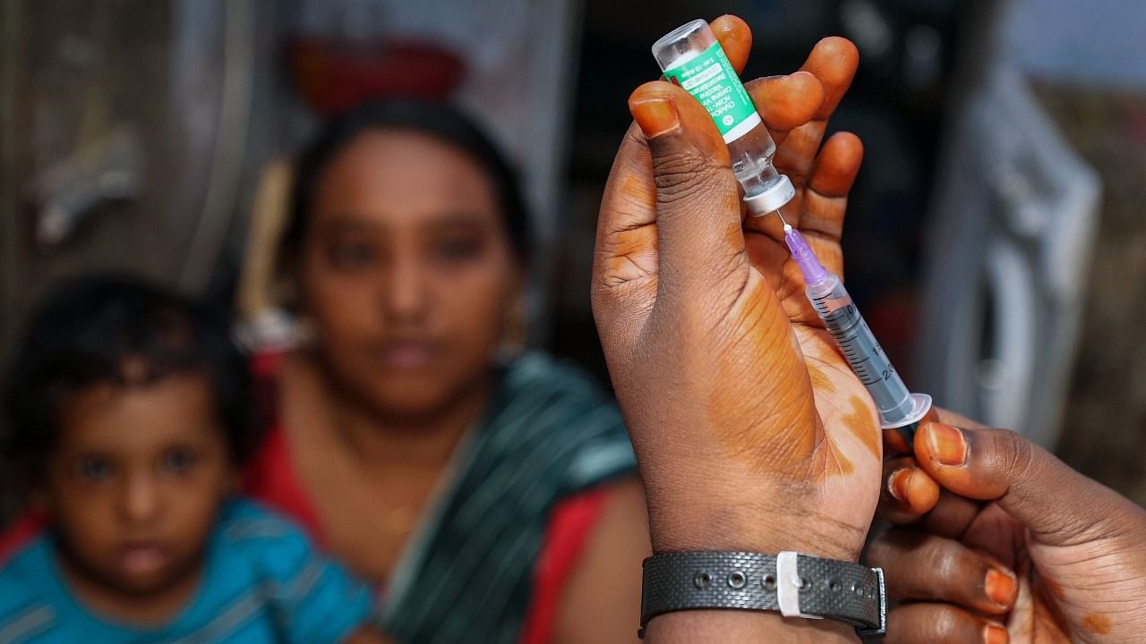 A medic prepares to administer a dose of Covid-19 vaccine to a beneficiary during a door to door vaccination drive, in Chennai, Wednesday. Credit: PTI Photo