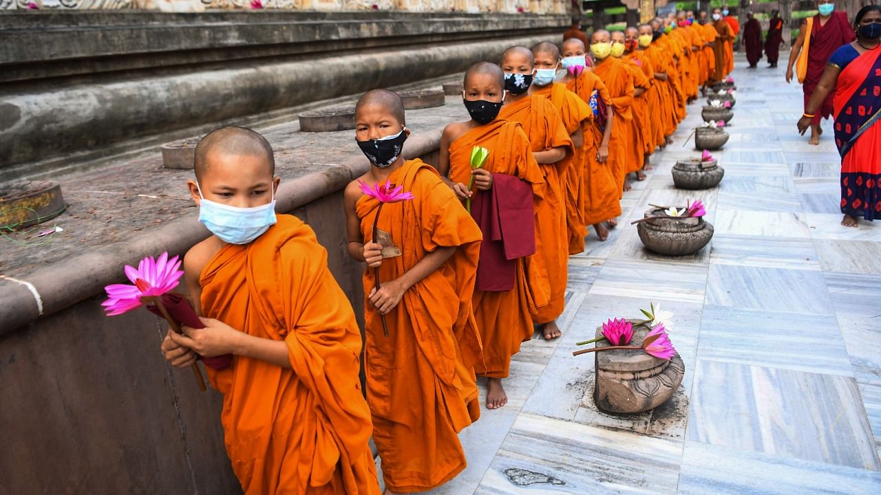 Novice Buddhist monks offer prayers at the Mahabodhi Temple in Bodh Gaya. Credit: PTI Photo