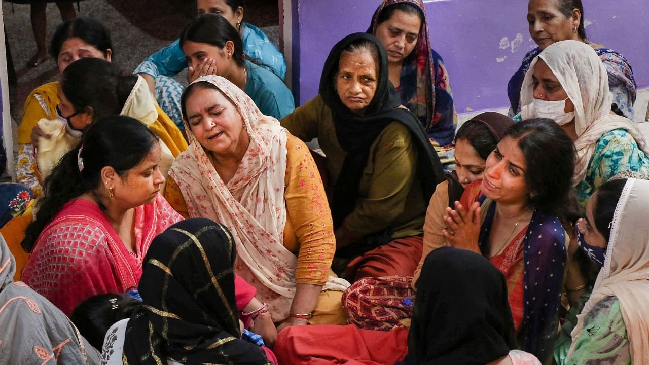 amily members mourn Deepak Chand, a teacher who was killed during a militant attack, in Jammu. Credit: PTI File Photo