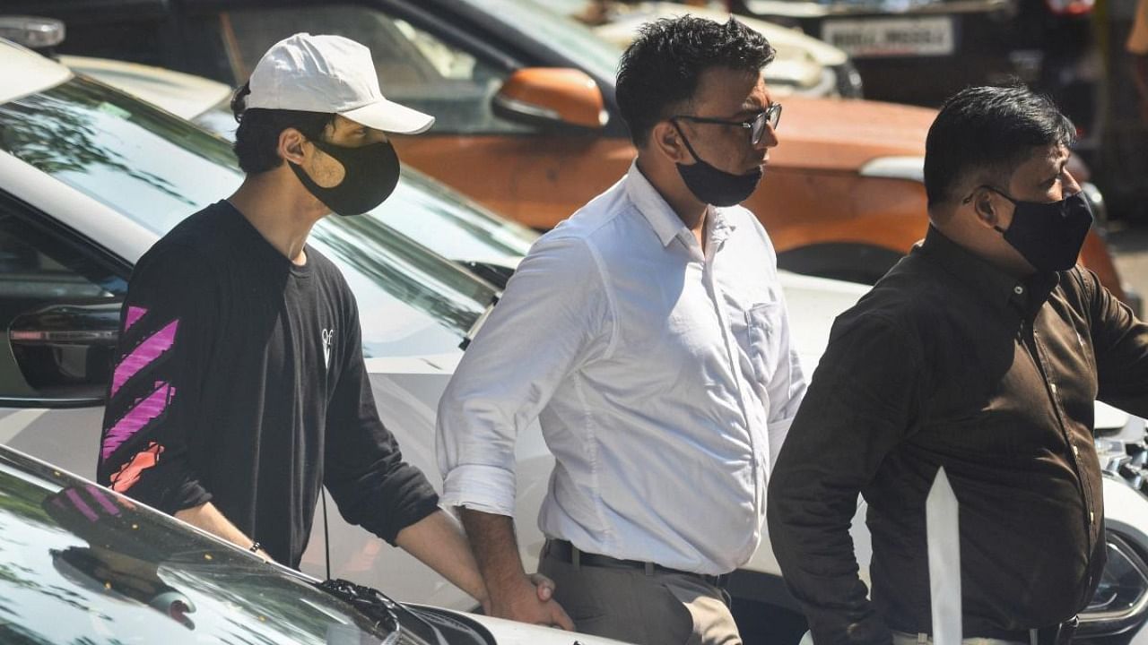 Bollywood actor Shah Rukh Khan's son Aryan Khan, accused in a drug bust case, being taken from NCB office to the Killa court in Mumbai. Credit: PTI Photo