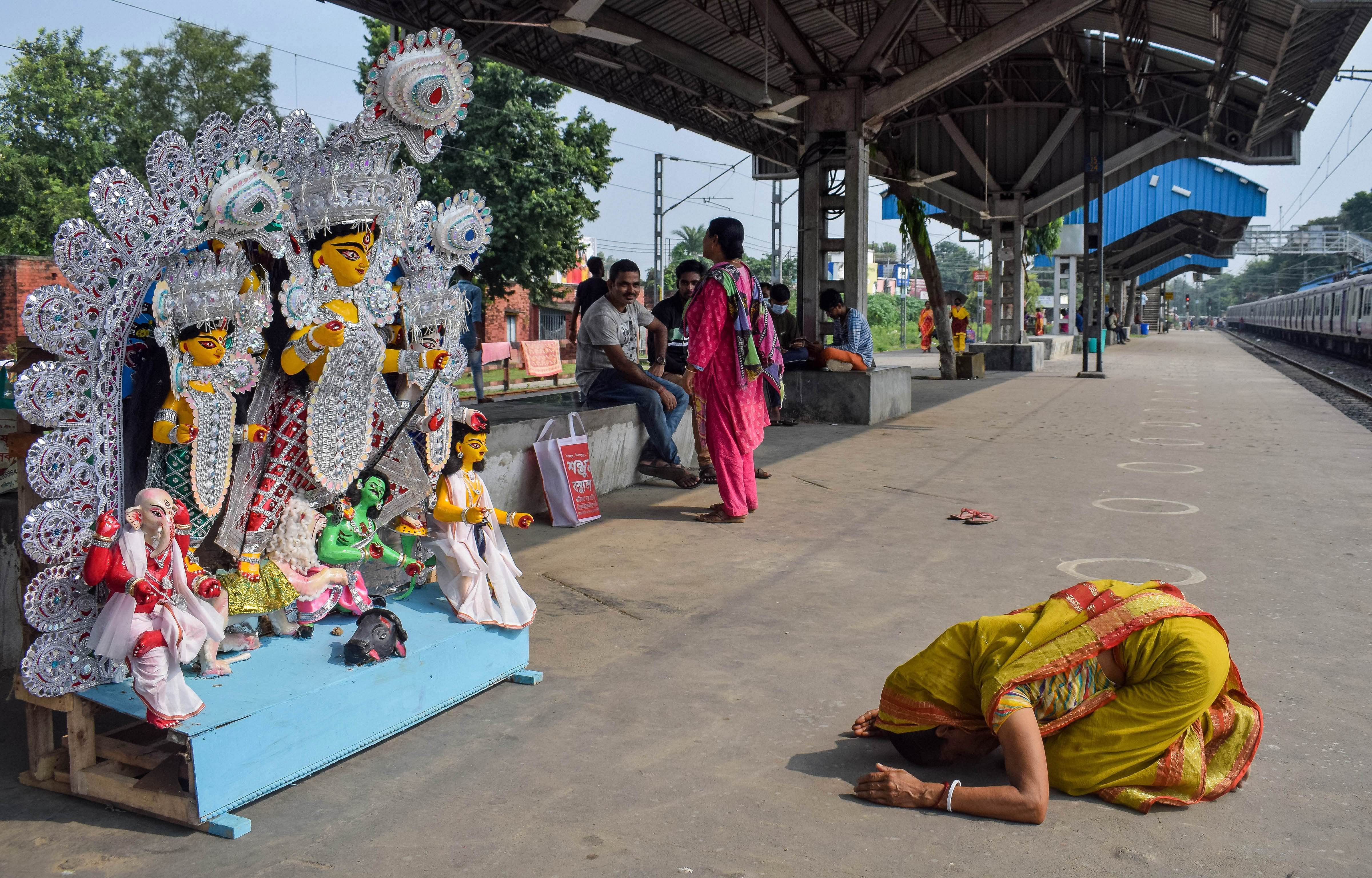  woman bows before an idol of Goddess Durga. Credit: PTI Photo