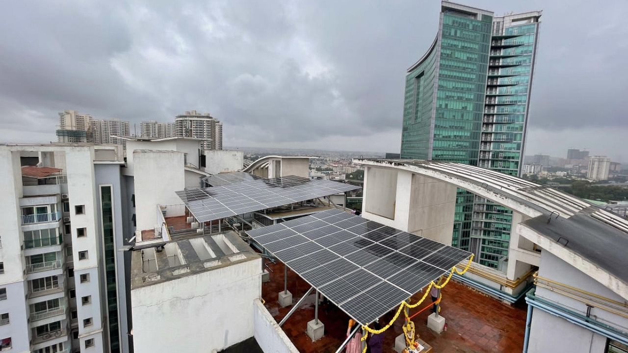Solar panels are seen atop building. Credit: DH Photo