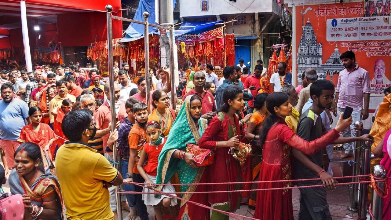 Devotees in large numbers wait in queues to offer prayers at Patan Devi temple during Navratri festival in Patna. Credit: PTI Photo