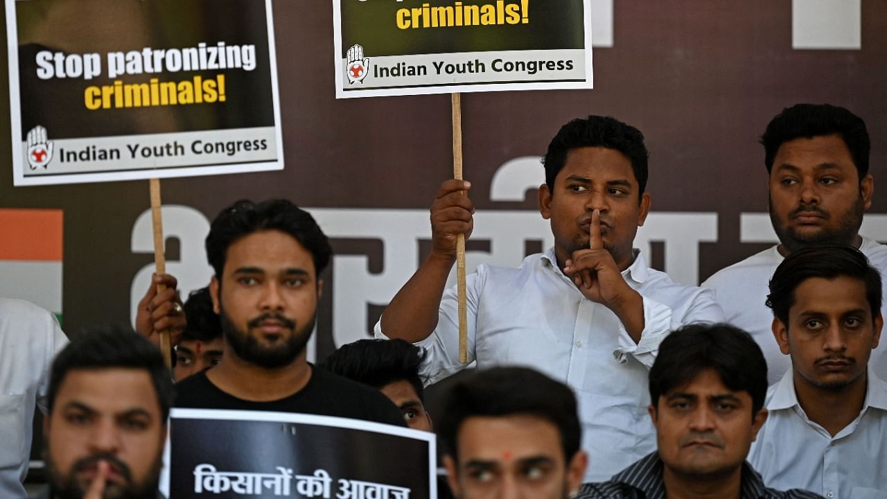 Activists of India’s youth Congress hold placards during a silent protest in New Delhi on October 11, 2021, days after at least eight people died in an incident involving protesting farmers in Lakhimpur Kheri district of Uttar Pradesh state. Credit: AFP Photo