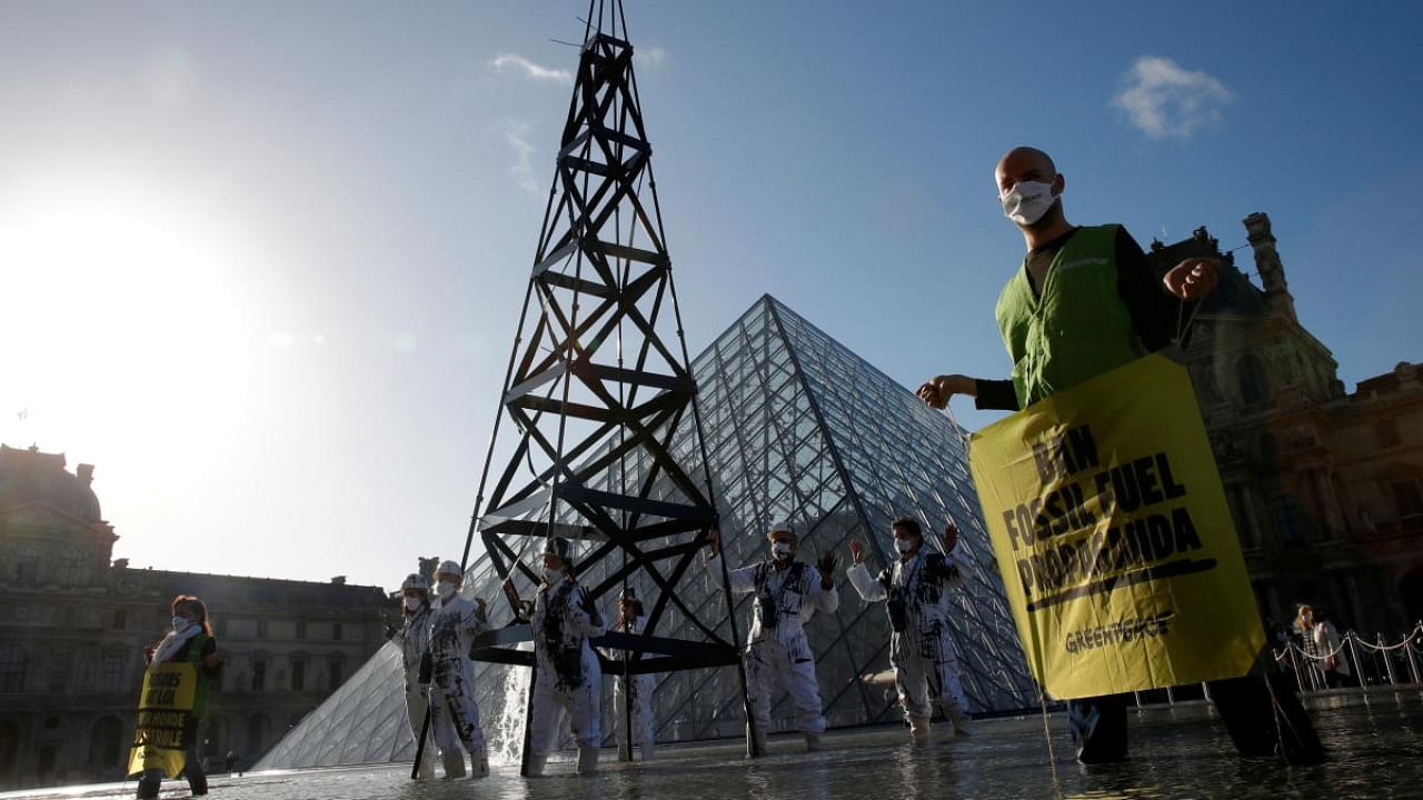 Greenpeace activists attend an action in Paris to protest against fossil fuel advertising and sponsorship in the European Union. Credit: Reuters Photo