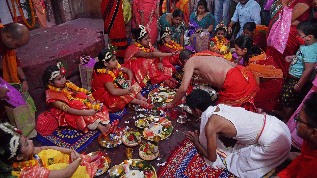 Hindu devotees offer prayers to girls dressed as Hindu goddess Durga for the 'Kumari' rituals during the Durga Puja festival at Kamakhya Temple in Guwahati. Credit: AFP Photo