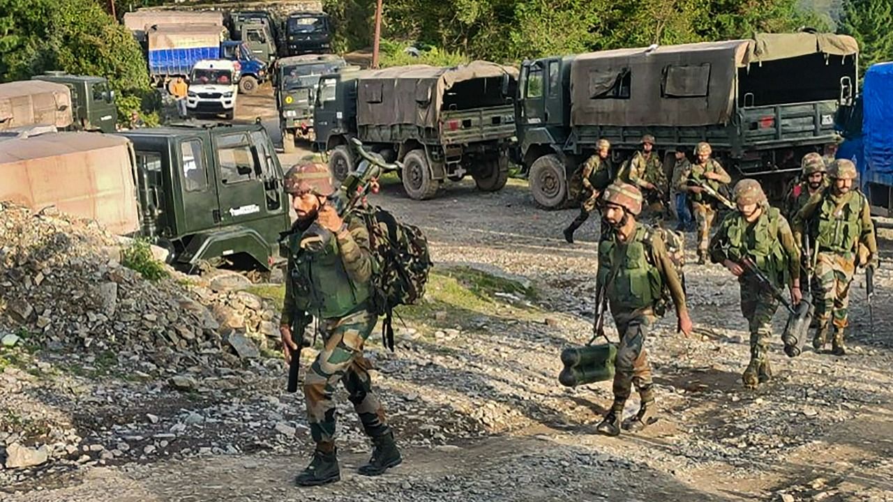 Security personnel patrol at the site of an encounter in Surankote area of Poonch district. Credit: PTI Photo