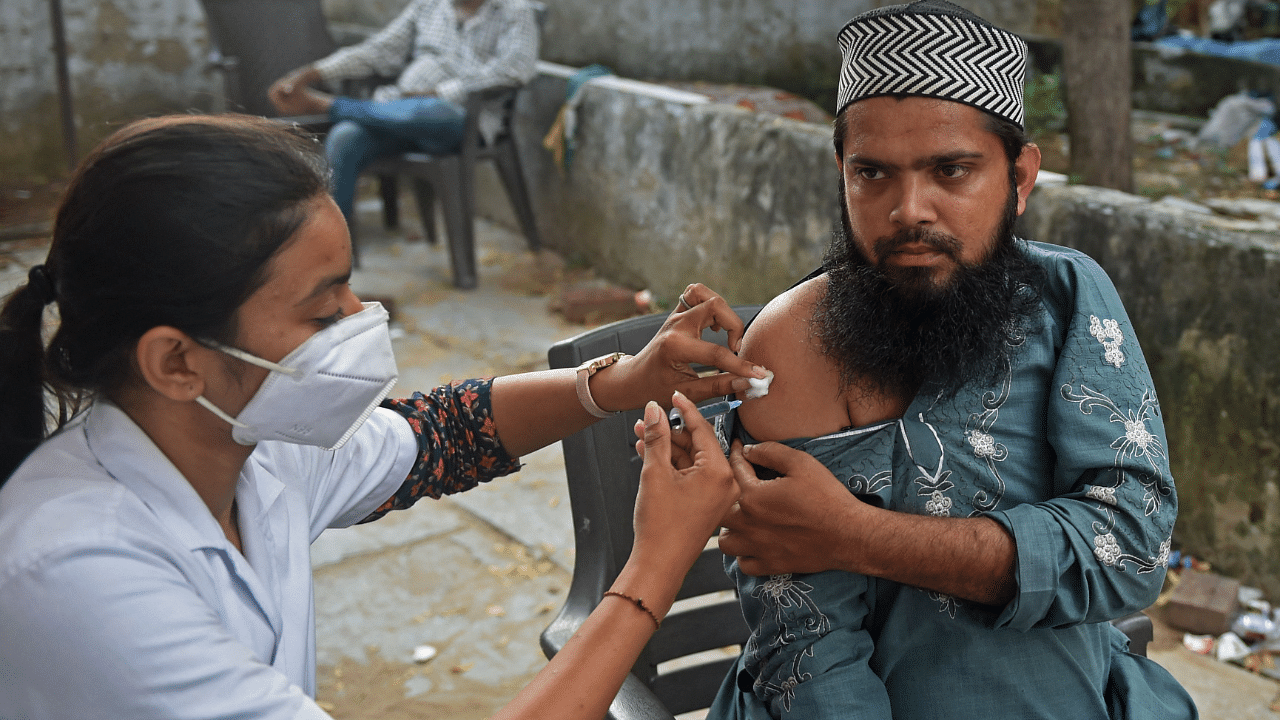 A health worker inoculates a man with a dose of the Covishield vaccine against the Covid-19. Credit: AFP Photo