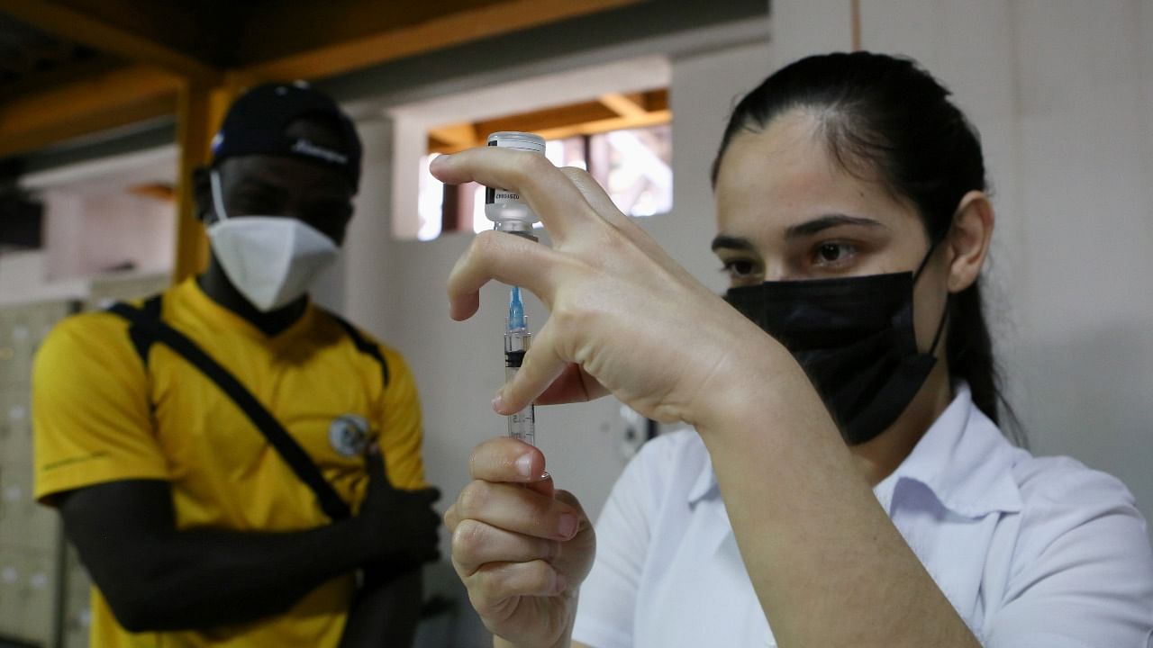 A health care worker prepares a vaccine dose. Credit: Reuters Photo
