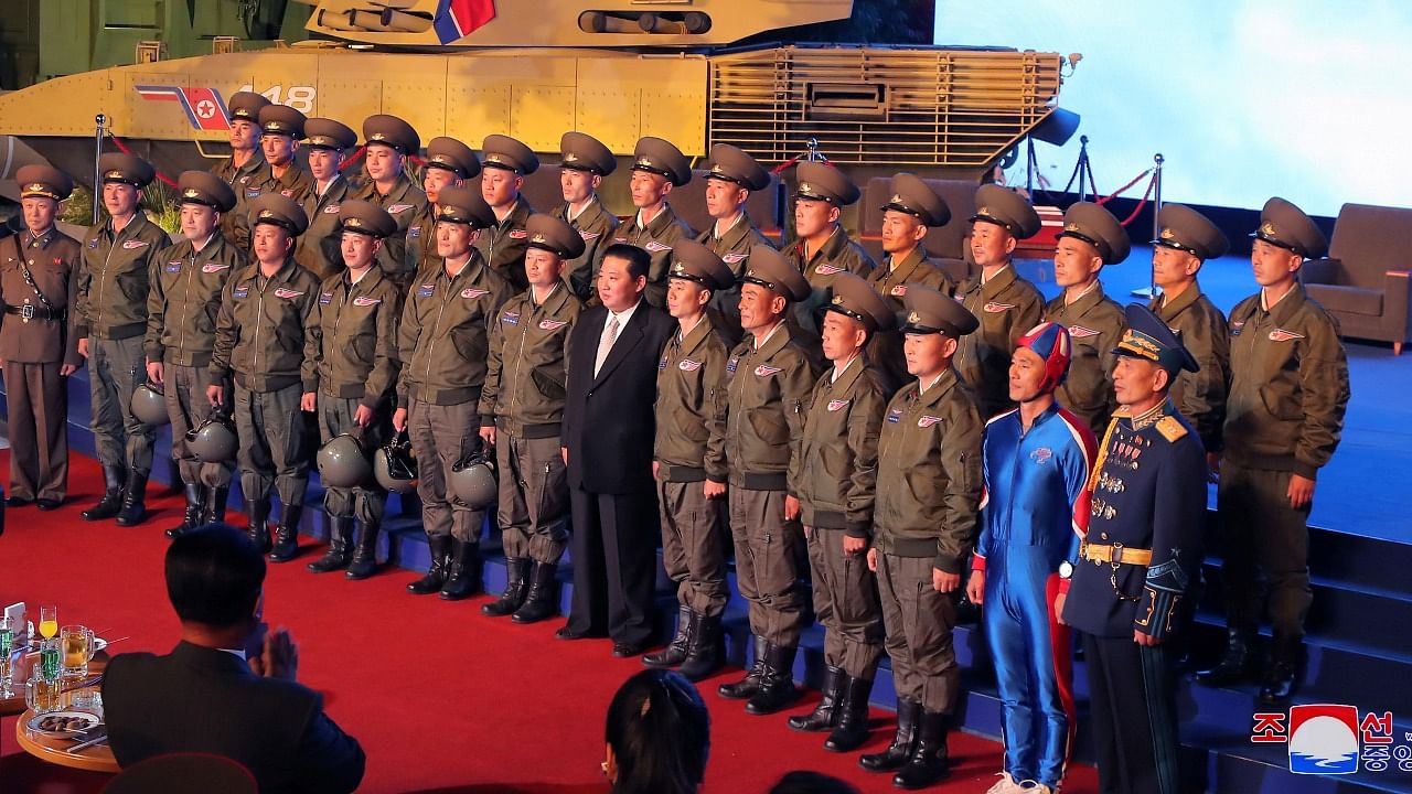 North Korea's leader Kim Jong Un takes pictures with military personnel at the Defence Development Exhibition, in Pyongyang, North Korea, in this undated photo released on October 12, 2021 by North Korea's Korean Central News Agency (KCNA). Credit: Reuters photo