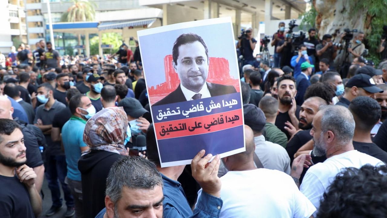 Supporters of Lebanese Shi'ite groups Hezbollah and Amal and the Christian Marada movement take part in a protest against Tarek Bitar, the lead judge of the port blast investigation, near the Justice Palace in Beirut. Credit: Reuters photo