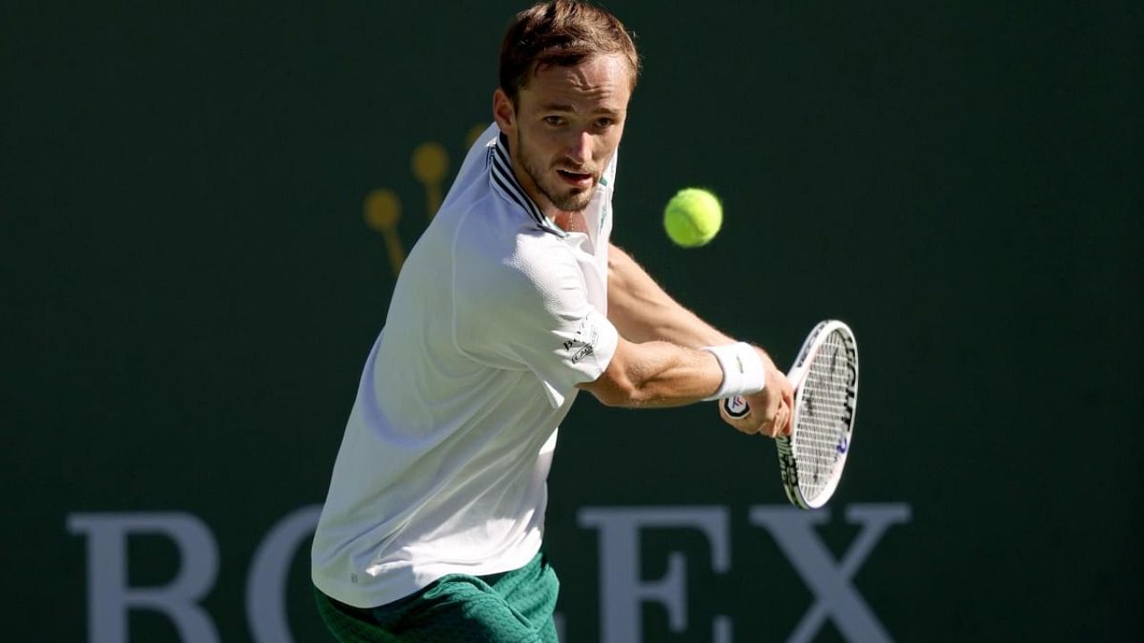 :Daniil Medvedev of Russia returns a shot to Grigor Dimitrov of Bulgaria during the BNP Paribas Open at the Indian Wells Tennis Garden. Credit: AFP Photo