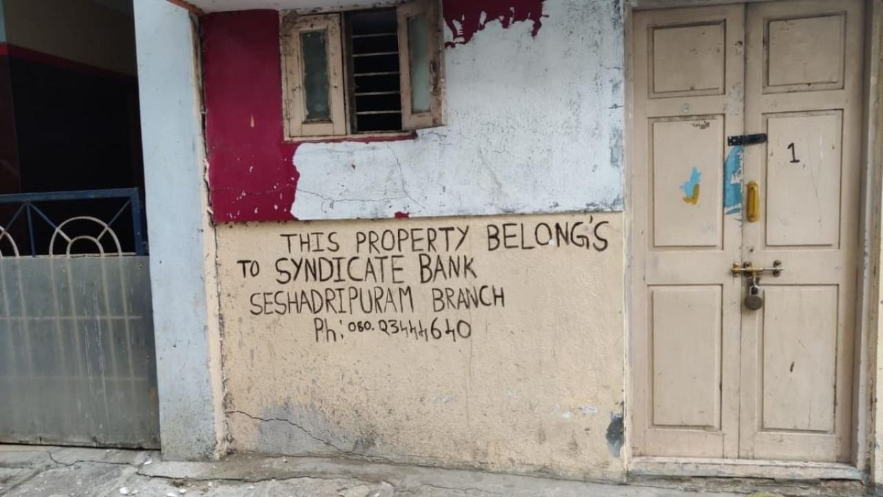 A writing on the wall claims the property belongs to the bank. Credit: DH Photo