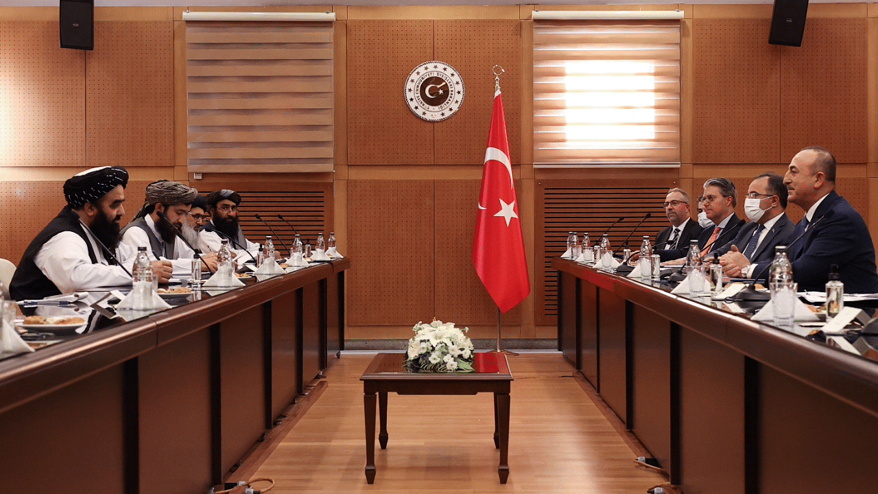 Turkish Foreign Minister Mevlut Cavusoglu, right, and Amir Khan Muttaqi, the acting foreign minister, of Afghanistan, left, speak during a meeting, in Ankara, Turkey. Credit: AP Photo