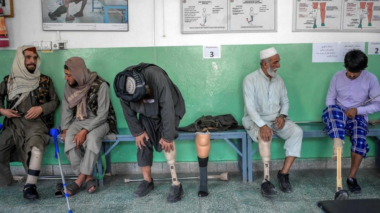 At this Red Cross-run rehabilitation centre in Kabul, former Afghan government soldiers and Taliban fighters adjust their new prostheses, living side by side. Credit: AFP Photo