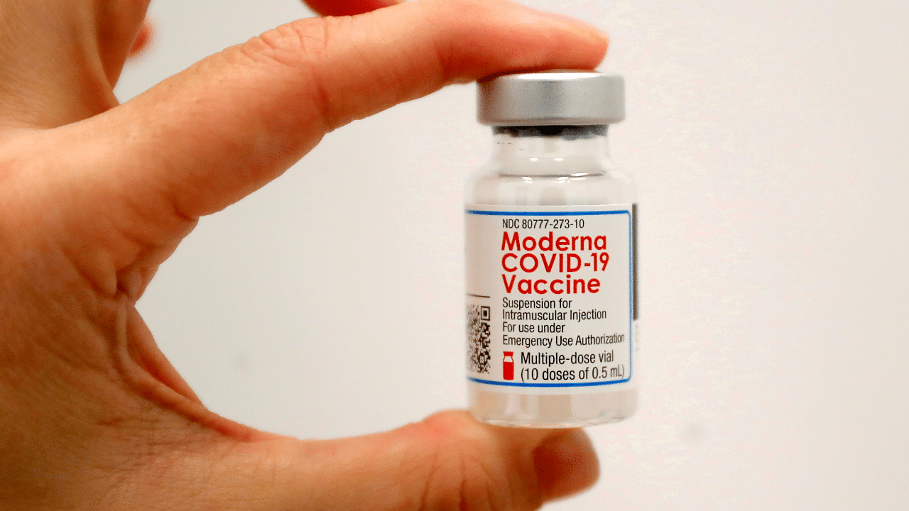 A healthcare worker holds a vial of the Moderna Covid-19 vaccine at a pop-up vaccination site. Credit: Reuters Photo