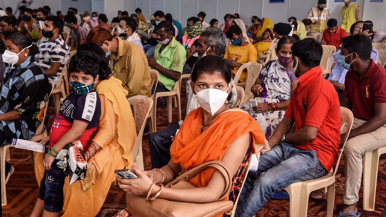 Beneficiaries wait in an observation room after receiving Covid-19 vaccine dose at a free vaccination camp organised by the Delhi government, in New Delhi, Sunday. Credit: PTI Photo