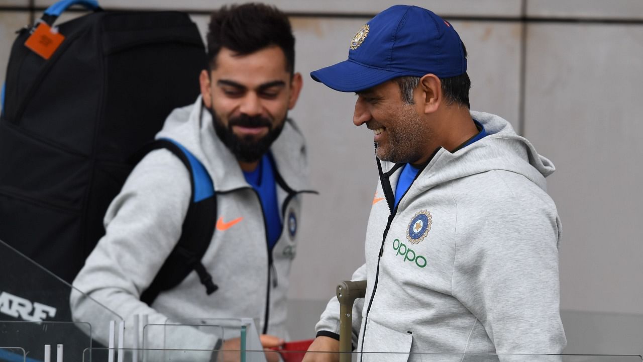 Virat Kohli with MS Dhoni. Credit: AFP File Photo