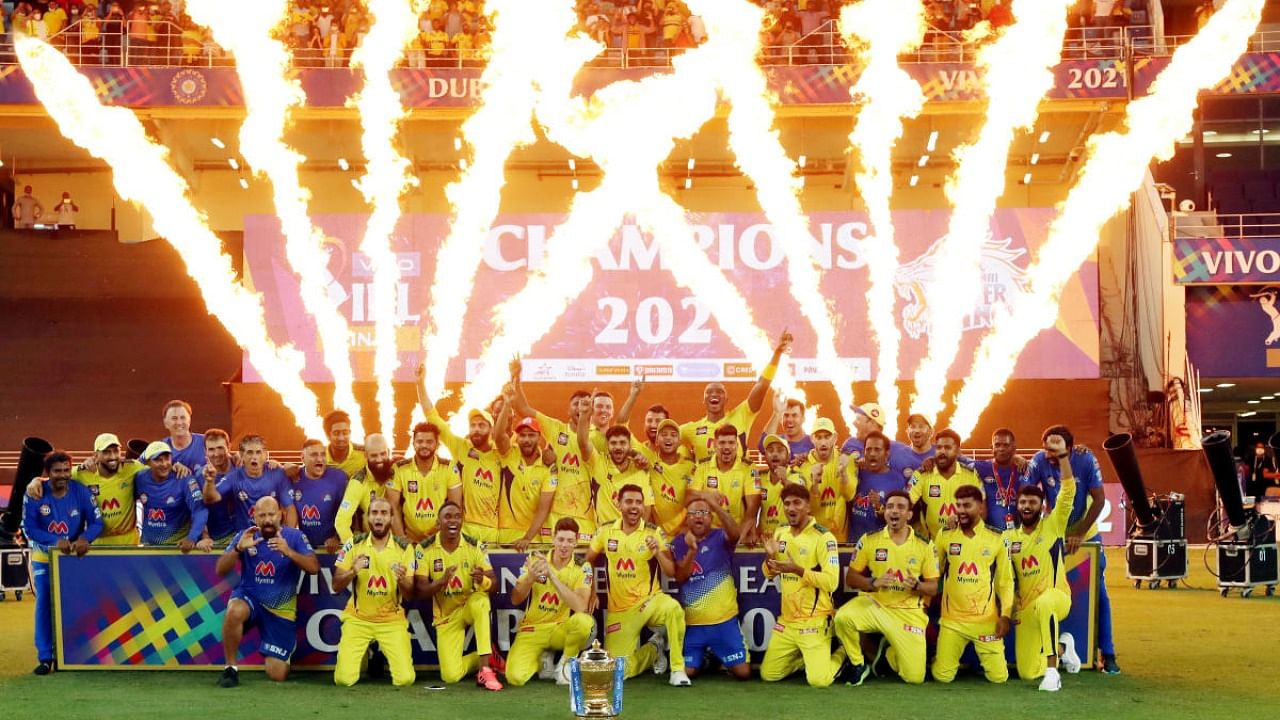 Chennai Super Kings players pose with the IPL trophy after winning final of the Indian Premier League 2021 between the Chennai Super Kings and the Kolkata Knight Riders, at the Dubai International Stadium, UAE. Credit: PTI Photo