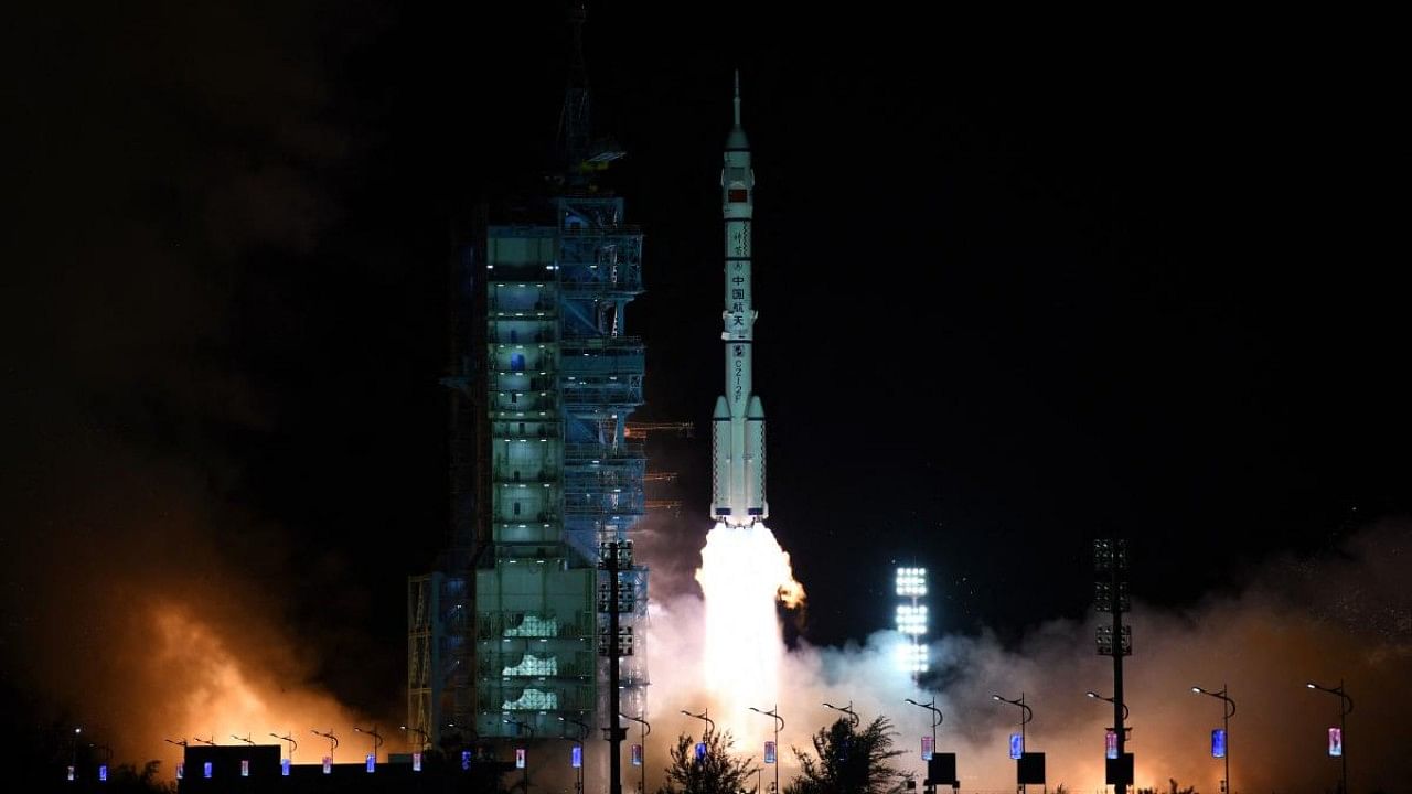The Long March-2F Y13 rocket, carrying the Shenzhou-13 spacecraft and three astronauts in China's second crewed mission to build its own space station, launches at Jiuquan Satellite Launch Center. Credit: AFP Photo